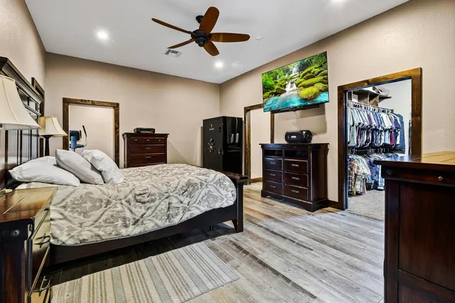 a bedroom with a bed and wooden floor