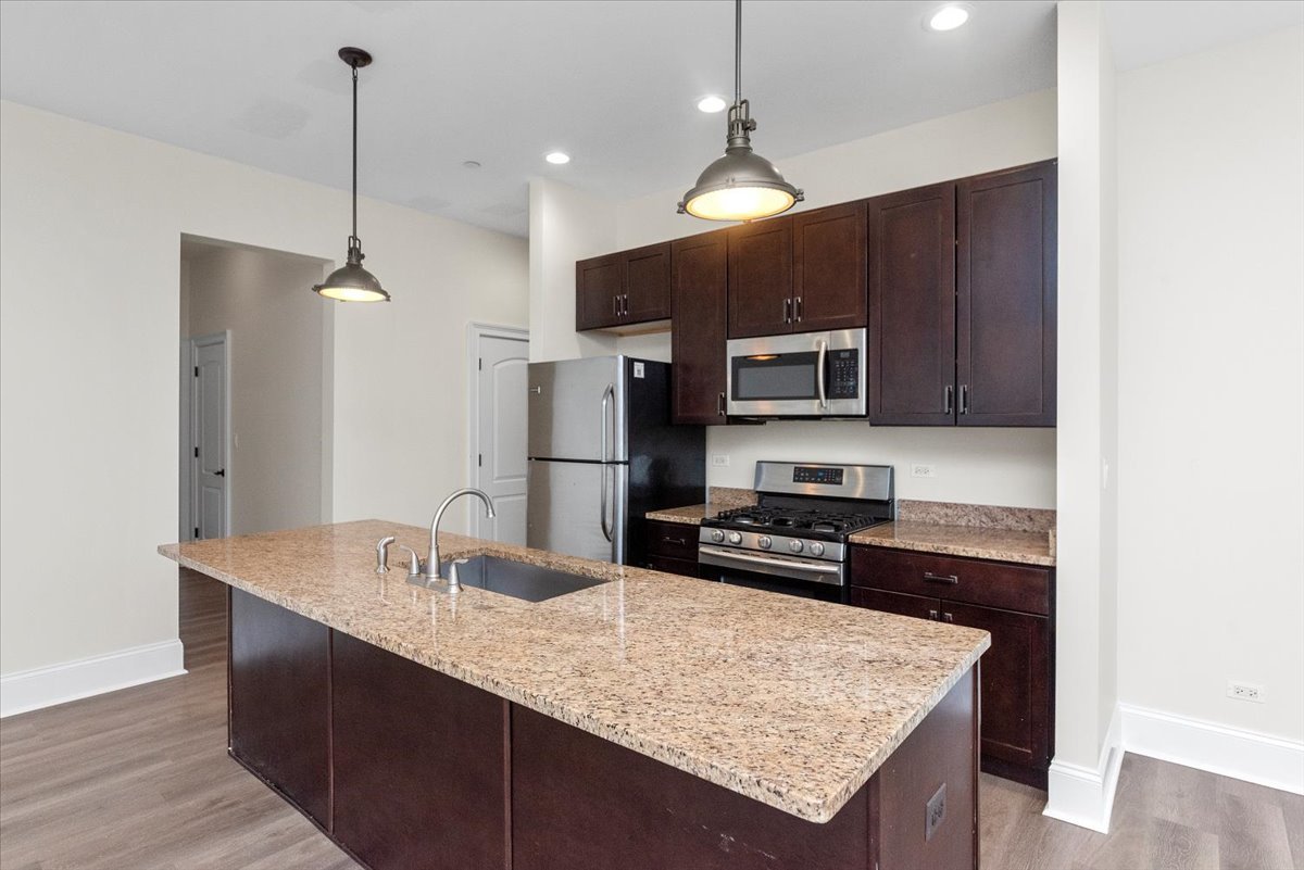 2500 Green Bay Road, Unit 403 Evanston, IL 60201 - Photo 2 of 16 a kitchen with stainless steel appliances granite countertop a sink refrigerator and microwave