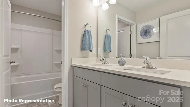 a bathroom with a tub a sink and a mirror