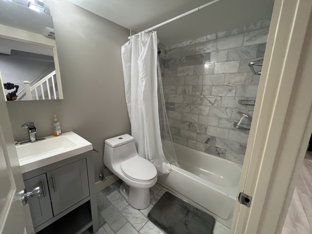 39 Snow Street, Unit 1 Boston, MA 02135 - Photo 18 of 35 a bathroom with a shower a toilet and a sink