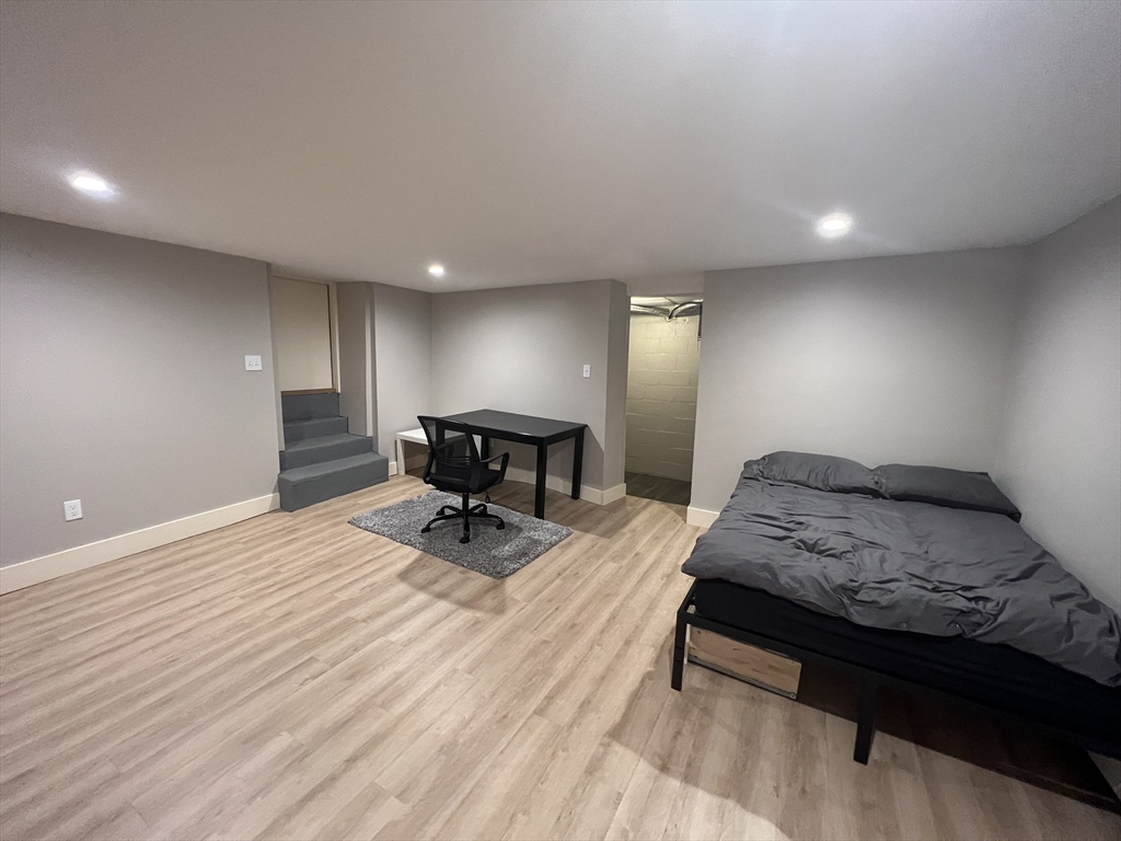 39 Snow Street, Unit 1 Boston, MA 02135 - Photo 19 of 35 a spacious bedroom with a bed and chair