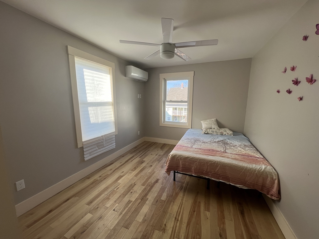 39 Snow Street, Unit 1 Boston, MA 02135 - Photo 27 of 35 a bedroom with a bed and wooden floor