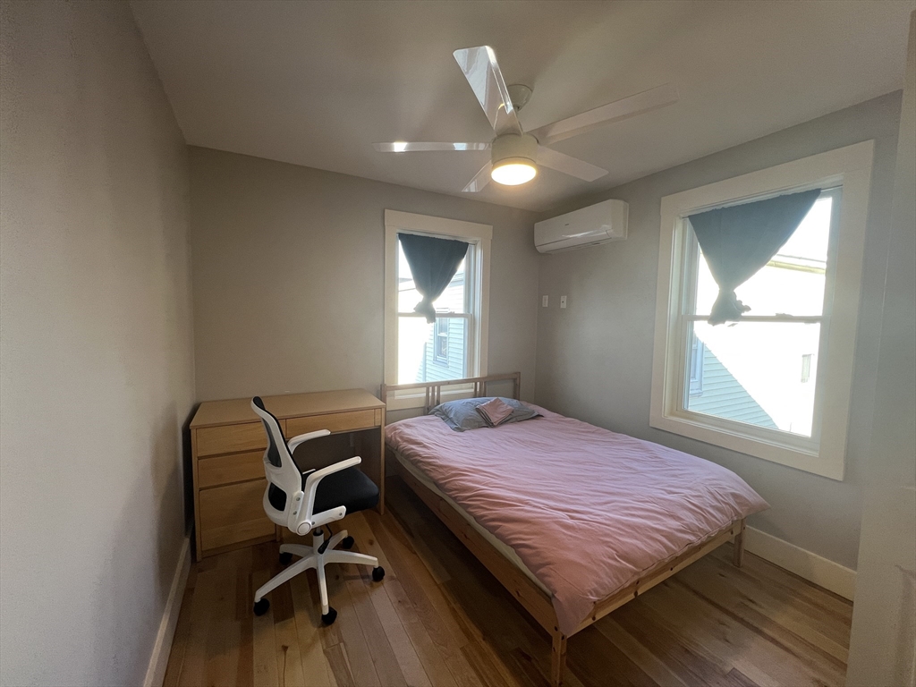 39 Snow Street, Unit 1 Boston, MA 02135 - Photo 29 of 35 a bed sitting in a bedroom next to a window