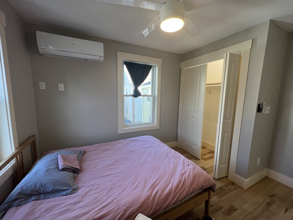 39 Snow Street, Unit 1 Boston, MA 02135 - Photo 30 of 35 a bedroom with a bed and wooden floor