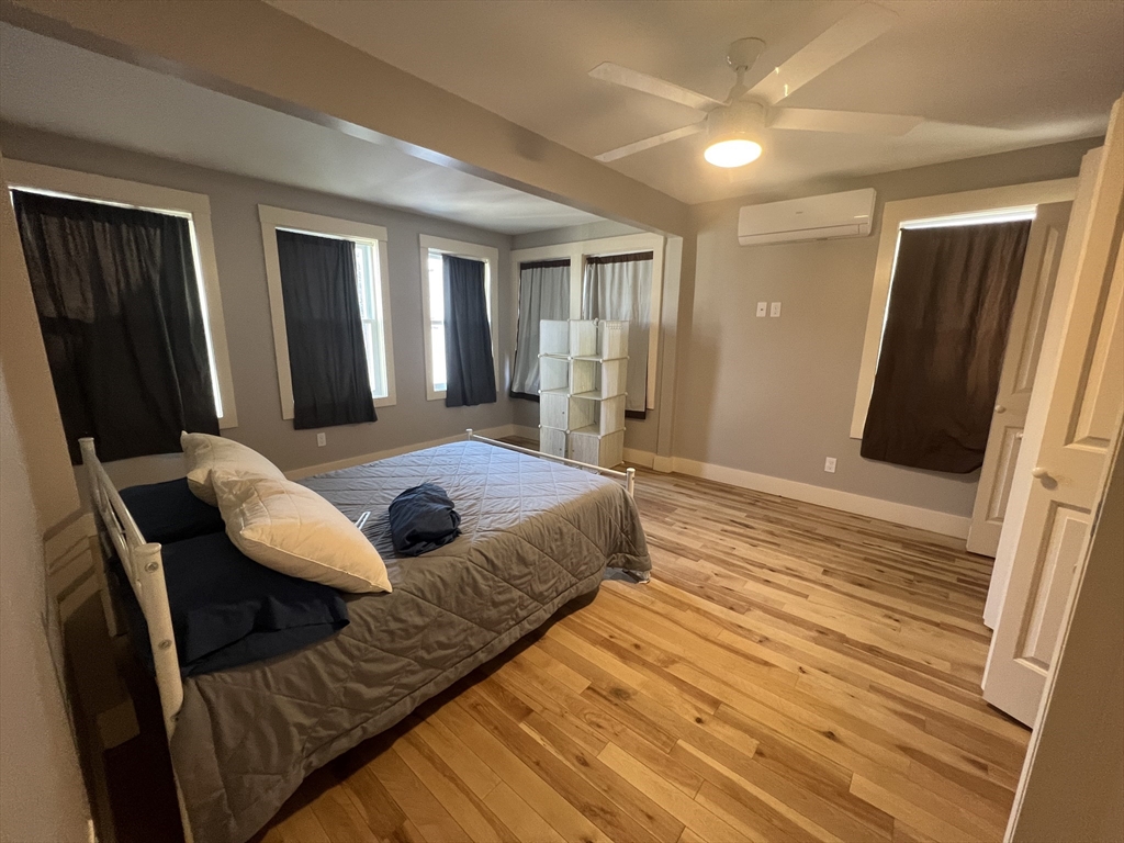 39 Snow Street, Unit 1 Boston, MA 02135 - Photo 31 of 35 a bedroom with a bed and wooden floor