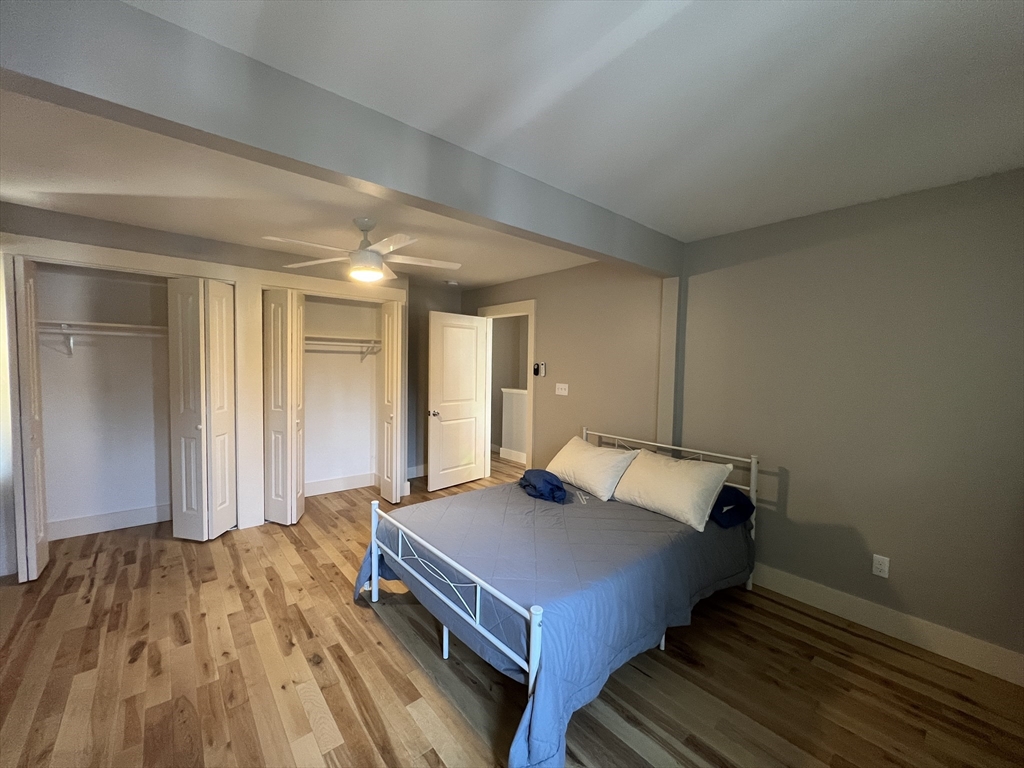 39 Snow Street, Unit 1 Boston, MA 02135 - Photo 32 of 35 a bedroom with a bed and wooden floor