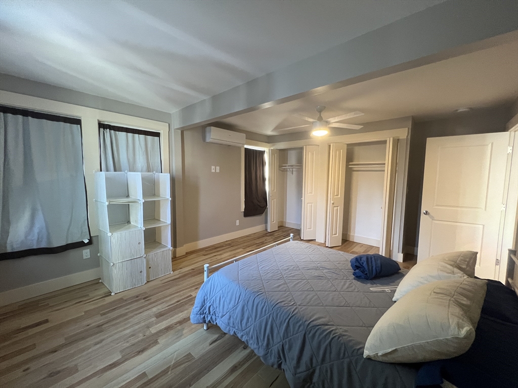 39 Snow Street, Unit 1 Boston, MA 02135 - Photo 33 of 35 a spacious bedroom with a bed and a couch