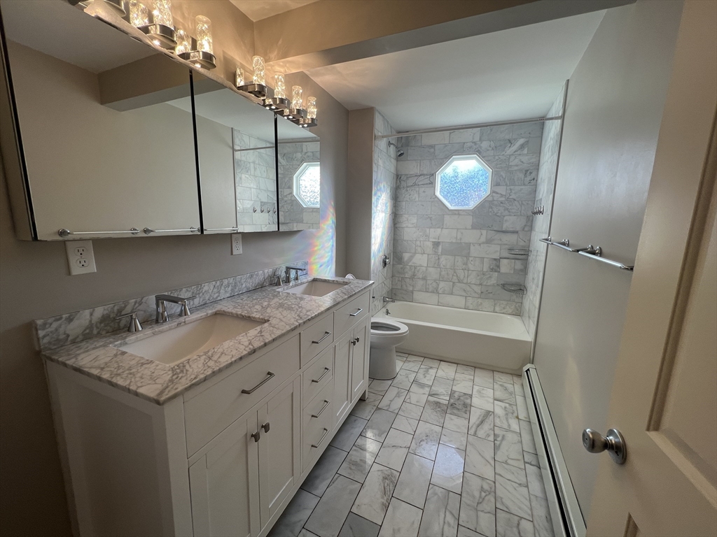 39 Snow Street, Unit 1 Boston, MA 02135 - Photo 35 of 35 a bathroom with a sink and a mirror