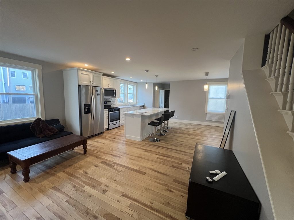 39 Snow Street, Unit 1 Boston, MA 02135 - Photo 8 of 35 a living room with furniture and a table