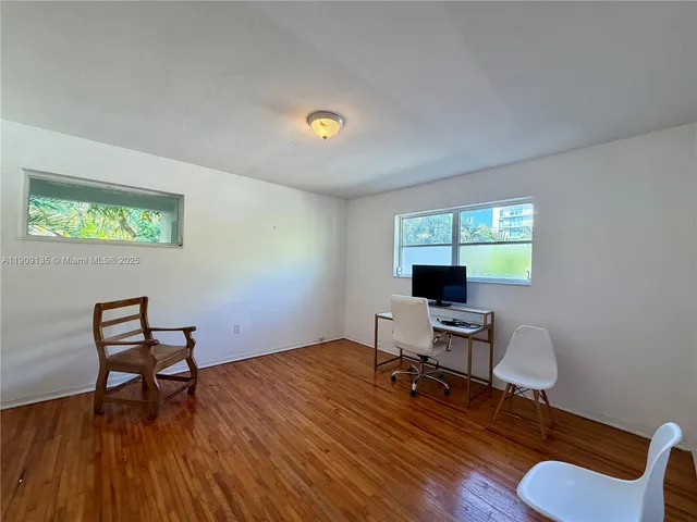 a workspace with furniture hardwood and a window