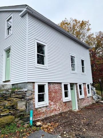 a front view of a house with plants