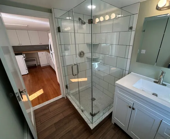 a bathroom with a sink a toilet and shower