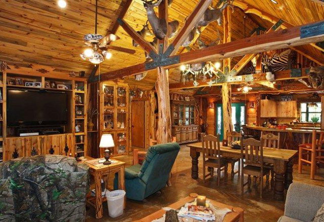 a living room with furniture a flat screen tv and floor to ceiling window