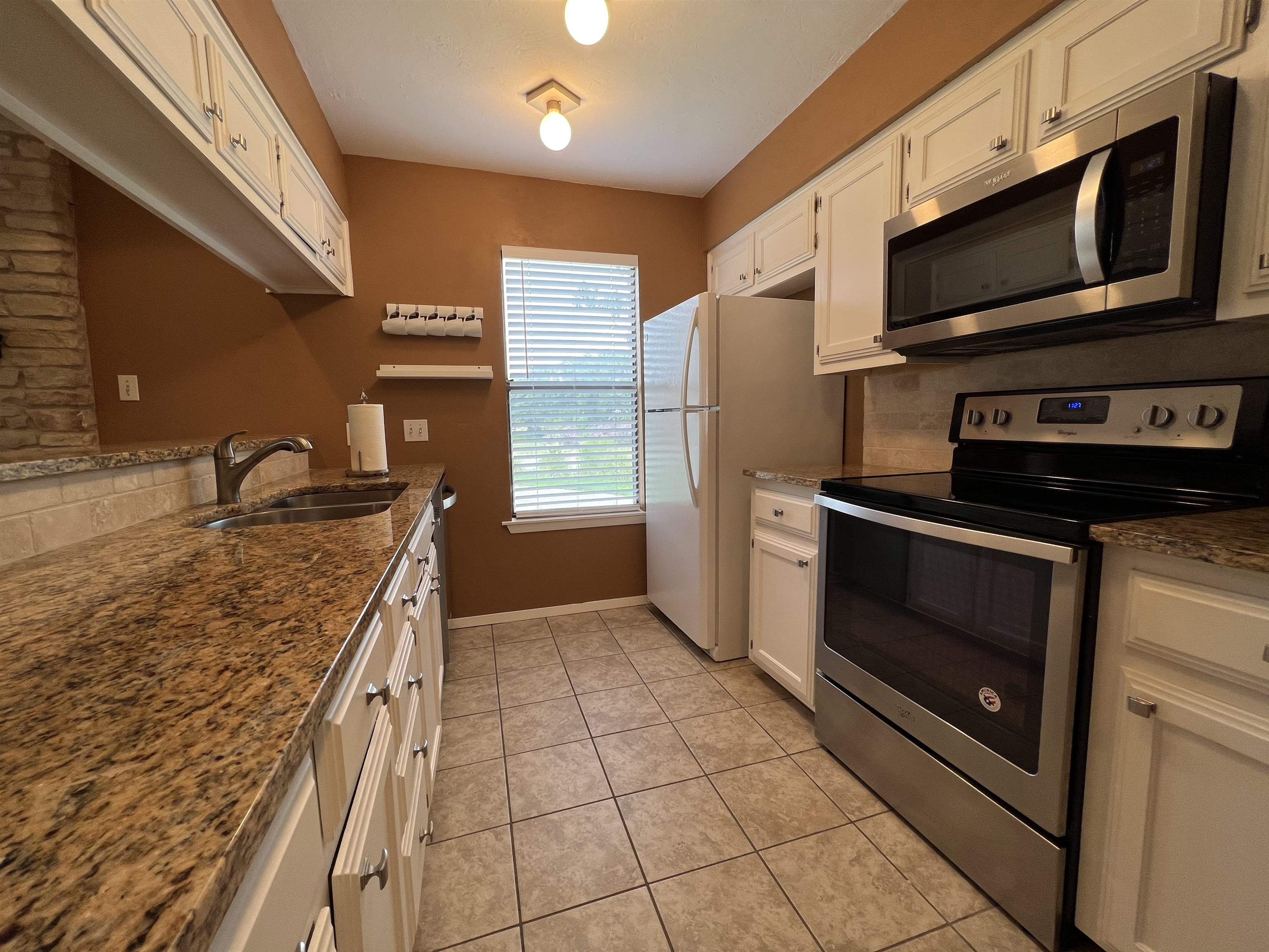 116 Dawn, Unit B Horseshoe Bay, TX 78657 - Photo 14 of 24 a kitchen with stainless steel appliances granite countertop a stove microwave and sink