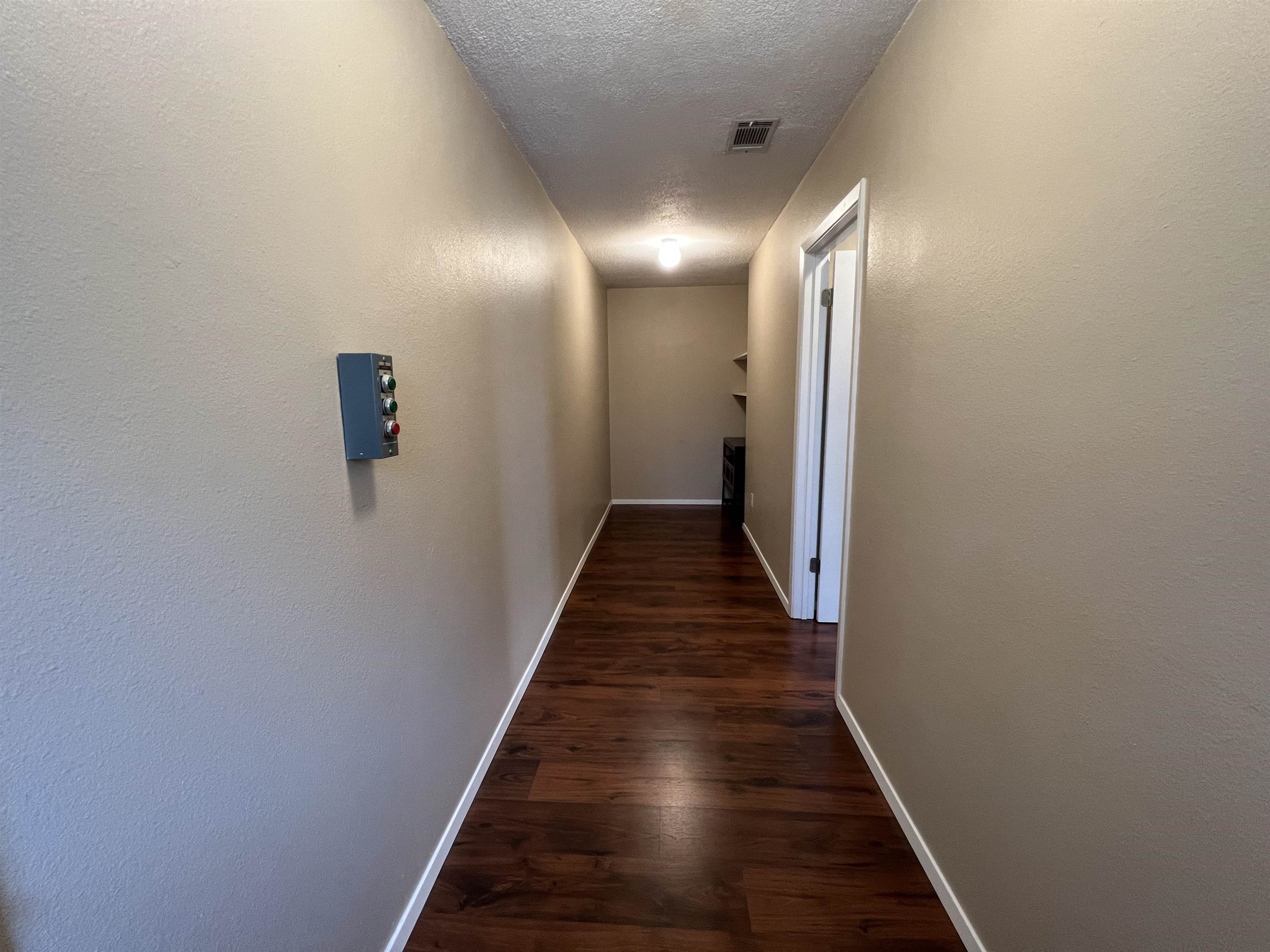 116 Dawn, Unit B Horseshoe Bay, TX 78657 - Photo 16 of 24 a view of hallway with wooden floor