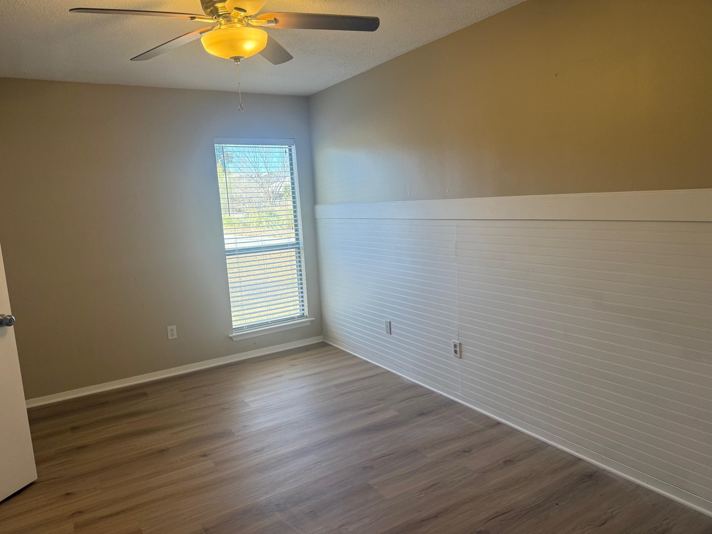 116 Dawn, Unit B Horseshoe Bay, TX 78657 - Photo 5 of 24 a view of an empty room with wooden floor and a window