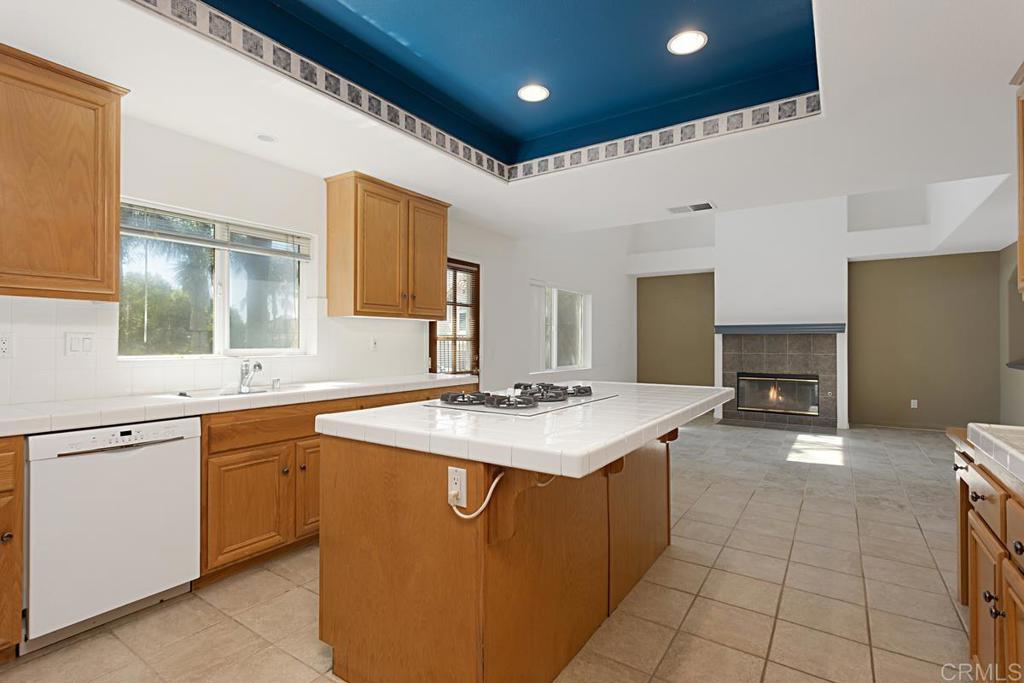 1691 Hubbard Place Escondido, CA 92027 - Photo 11 of 39 a kitchen with a sink and a stove top oven