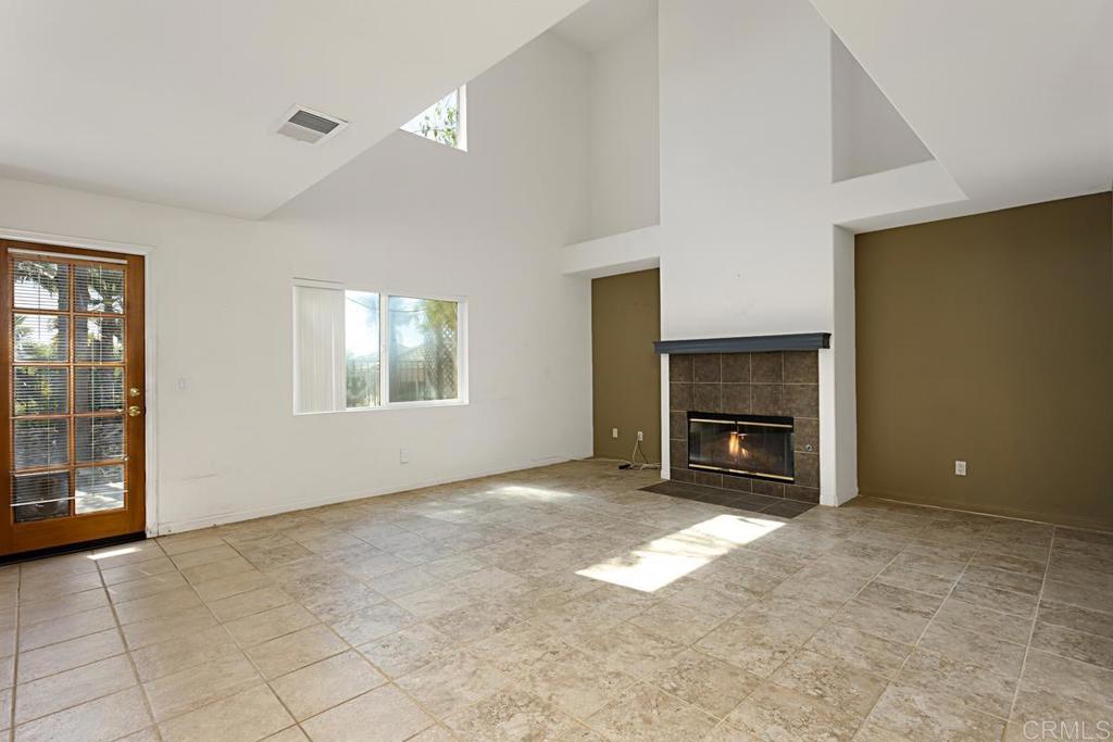 1691 Hubbard Place Escondido, CA 92027 - Photo 14 of 39 an empty room with windows and fireplace