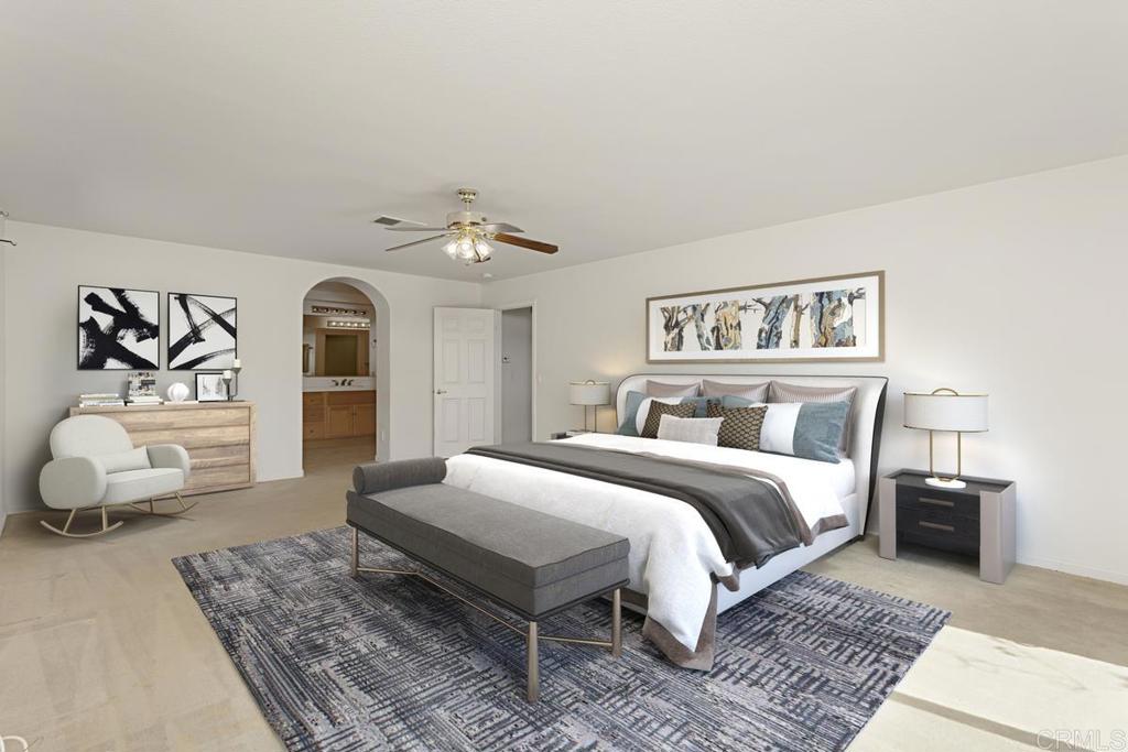 1691 Hubbard Place Escondido, CA 92027 - Photo 20 of 39 a spacious bedroom with a large bed and a couch