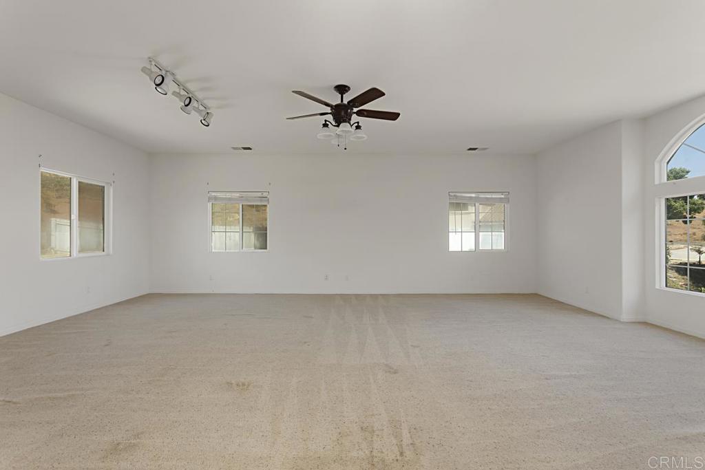 1691 Hubbard Place Escondido, CA 92027 - Photo 28 of 39 an empty room with windows and fan