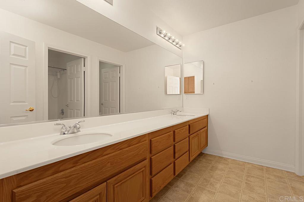 1691 Hubbard Place Escondido, CA 92027 - Photo 31 of 39 a bathroom with a sink and a mirror
