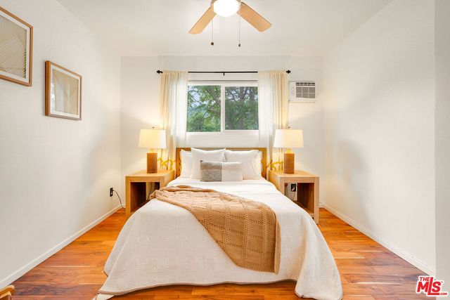 a bed sitting in a bedroom next to a window