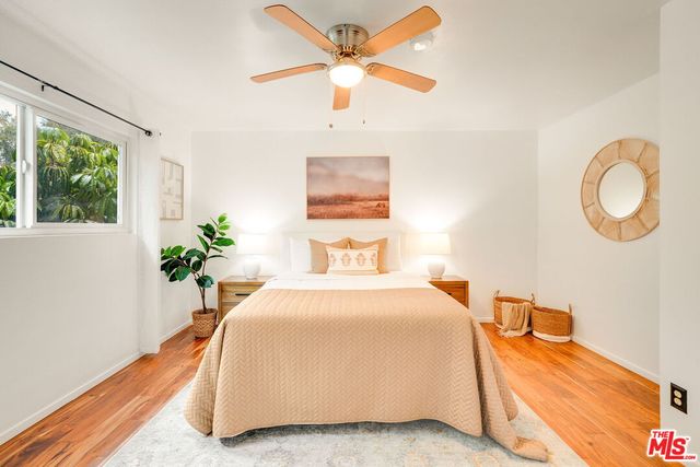 a bed room with a bed mirror and a window