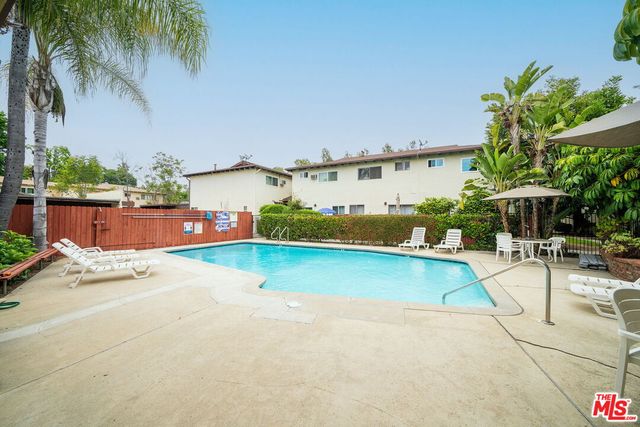 an outdoor space with pool and furniture