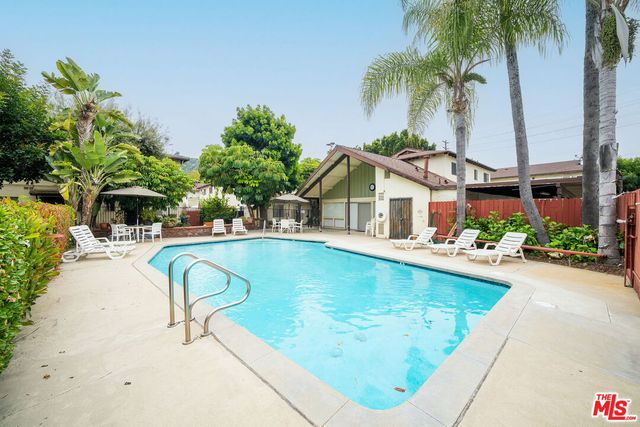 a swimming pool with outdoor seating and yard
