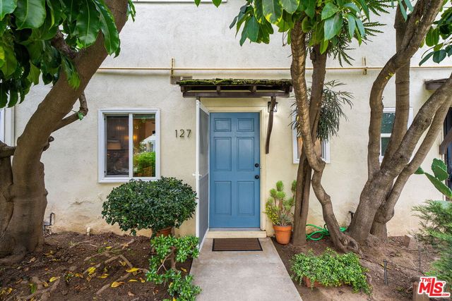 a house with palm tree in front of it