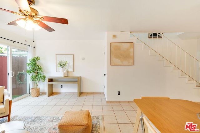 a bedroom with a bed and a chandelier fan