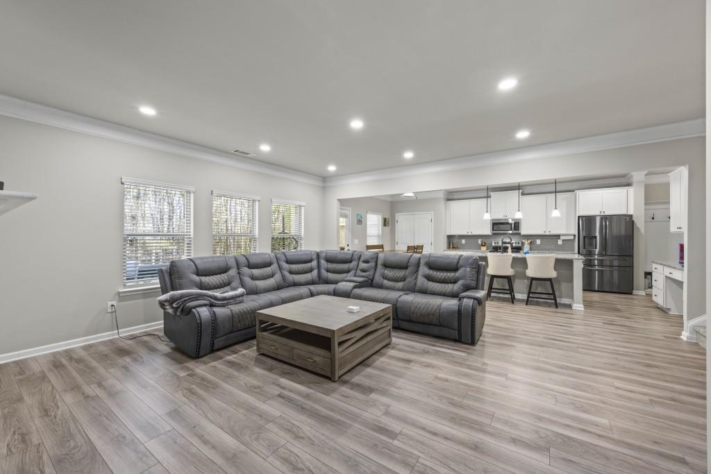 660 Country Ridge Drive Hoschton, GA 30548 - Photo 12 of 58 a living room with furniture and wooden floor