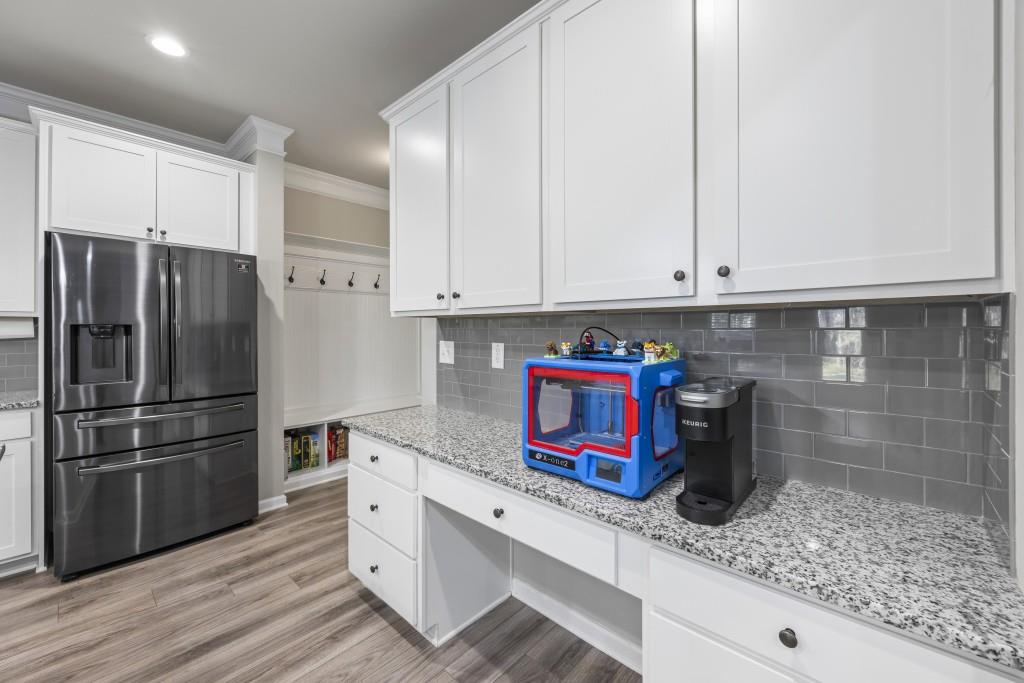 660 Country Ridge Drive Hoschton, GA 30548 - Photo 15 of 58 a kitchen with stainless steel appliances granite countertop a refrigerator sink and cabinets