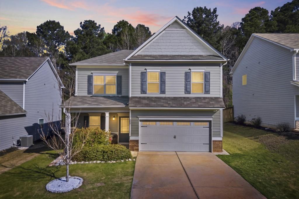 660 Country Ridge Drive Hoschton, GA 30548 - Photo 2 of 58 a front view of a house with a yard