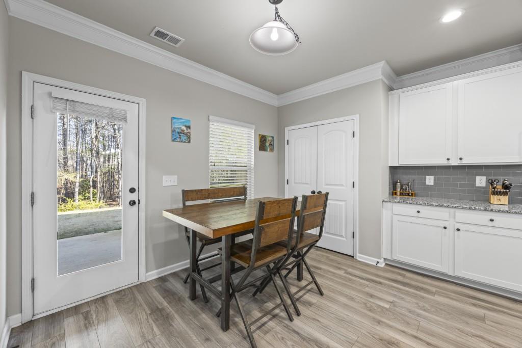 660 Country Ridge Drive Hoschton, GA 30548 - Photo 22 of 58 a view of a dining room with furniture and wooden floor