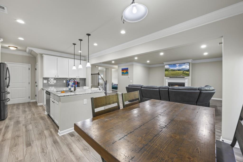 660 Country Ridge Drive Hoschton, GA 30548 - Photo 23 of 58 a large kitchen with a table and chairs