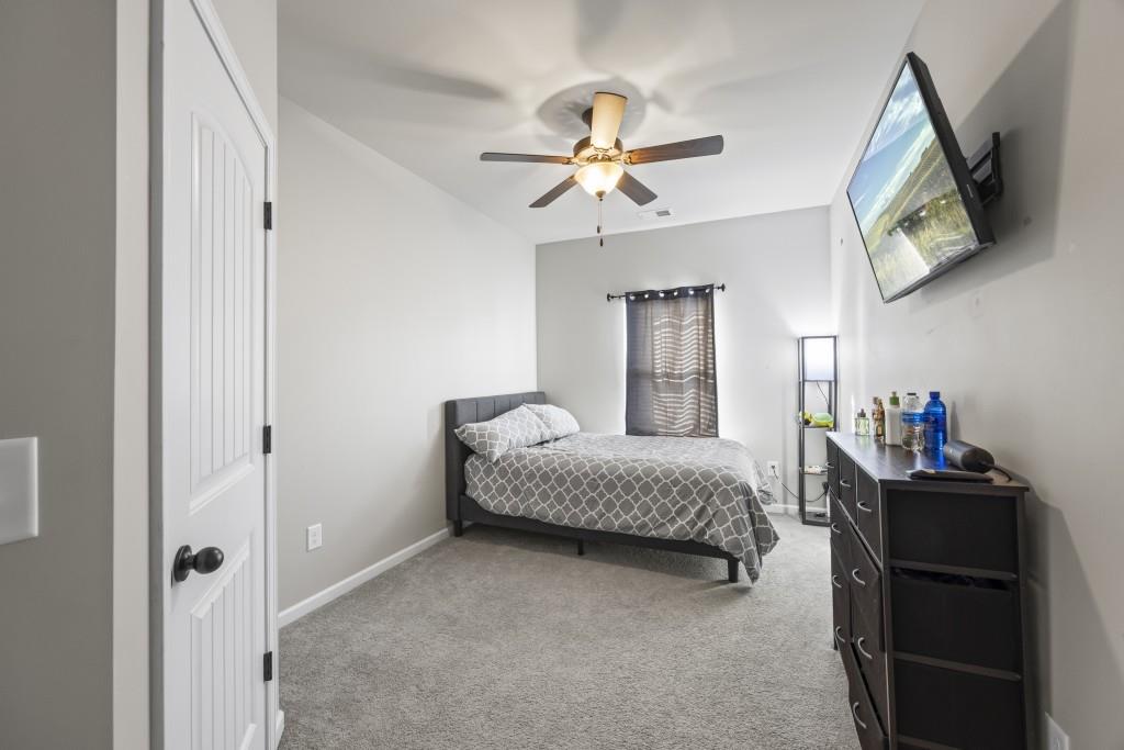 660 Country Ridge Drive Hoschton, GA 30548 - Photo 26 of 58 a living room with a bed furniture and a window