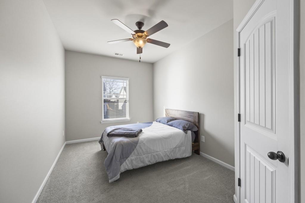 660 Country Ridge Drive Hoschton, GA 30548 - Photo 28 of 58 a bedroom with a bed and window