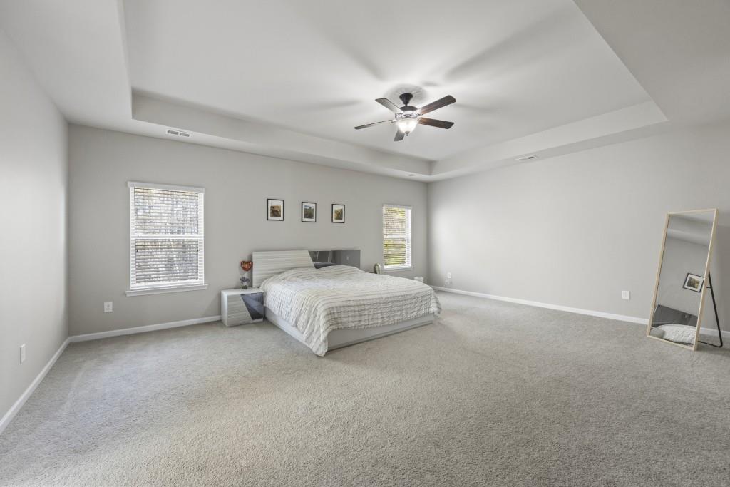 660 Country Ridge Drive Hoschton, GA 30548 - Photo 32 of 58 a spacious bedroom with a bed and a window