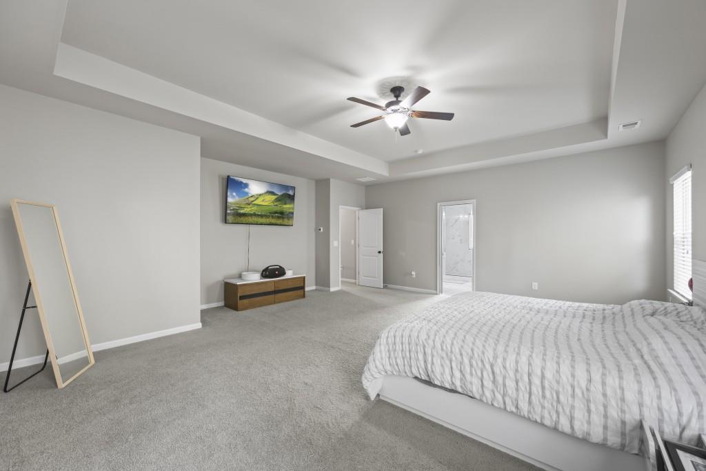 660 Country Ridge Drive Hoschton, GA 30548 - Photo 35 of 58 a bedroom with a bed and a window