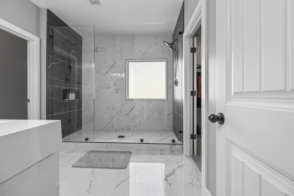 660 Country Ridge Drive Hoschton, GA 30548 - Photo 36 of 58 a bathroom with a bathtub and shower