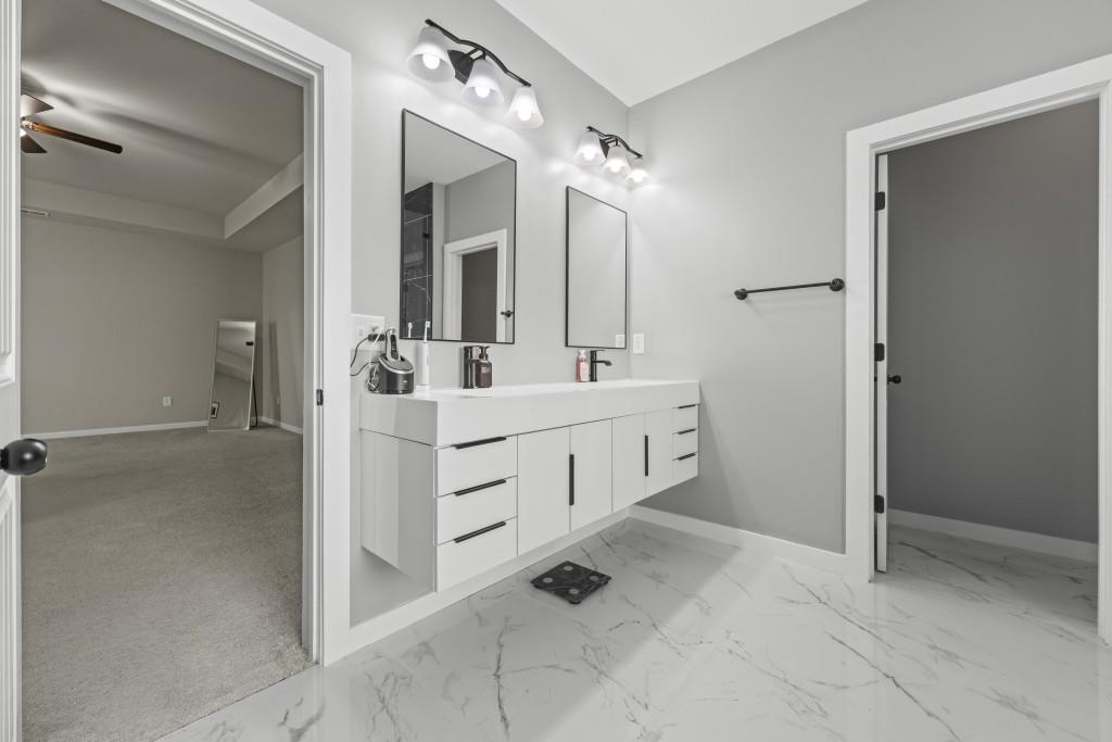 660 Country Ridge Drive Hoschton, GA 30548 - Photo 38 of 58 a bathroom with a double vanity sink a mirror and shower
