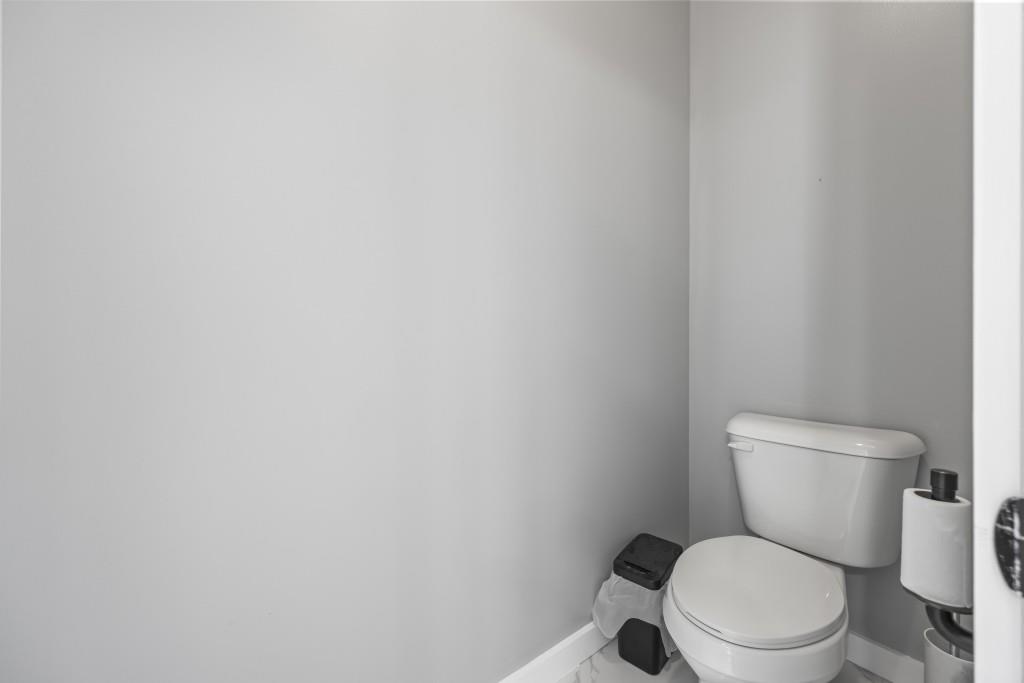 660 Country Ridge Drive Hoschton, GA 30548 - Photo 40 of 58 a white toilet sitting next to a white wall