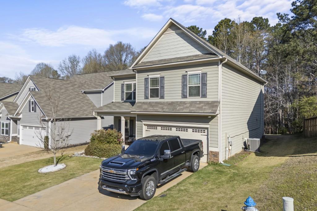 660 Country Ridge Drive Hoschton, GA 30548 - Photo 4 of 58 a front view of a house with garden