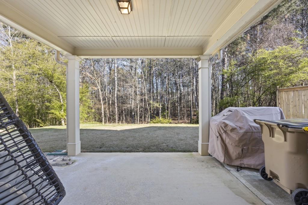 660 Country Ridge Drive Hoschton, GA 30548 - Photo 44 of 58 a view of a porch with furniture and garden