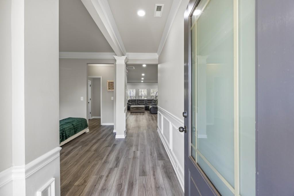 660 Country Ridge Drive Hoschton, GA 30548 - Photo 6 of 58 a view of a hallway view with wooden floor and staircase