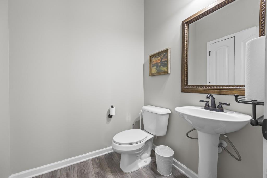 660 Country Ridge Drive Hoschton, GA 30548 - Photo 9 of 58 a bathroom with a toilet a sink and mirror