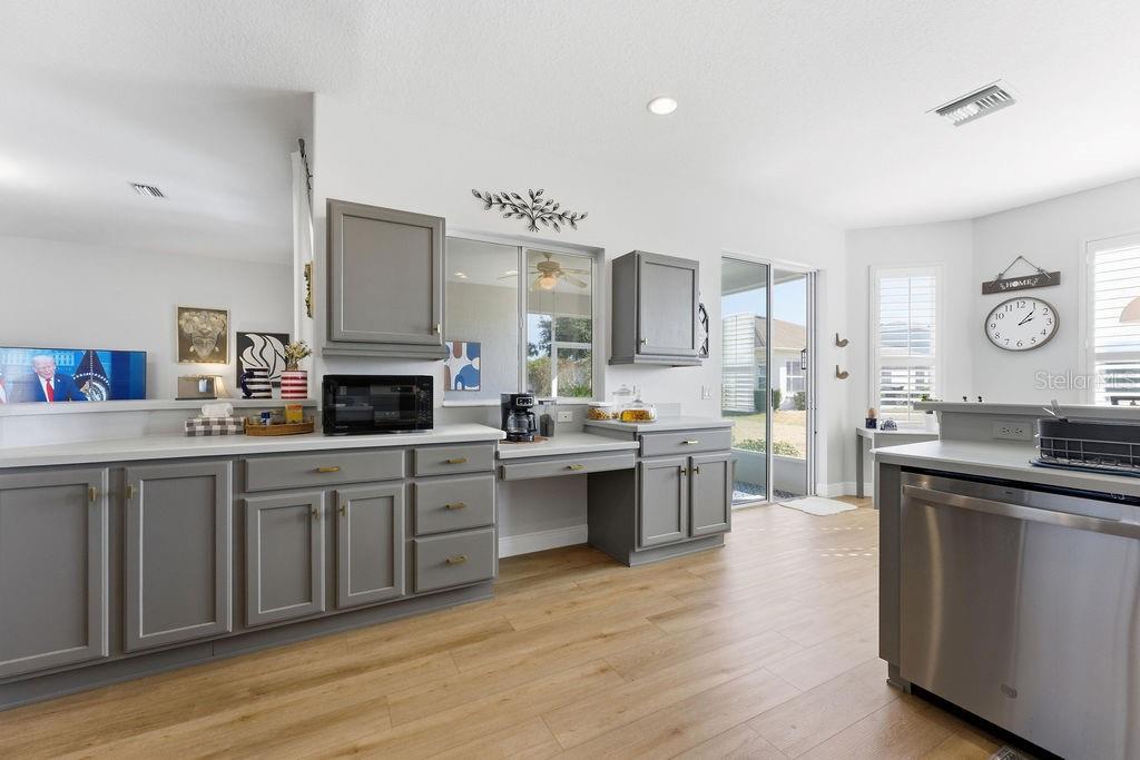 1338 Southwest 161st Place Ocala, FL 34473 - Photo 18 of 76 a large kitchen with cabinets wooden floor and stainless steel appliances