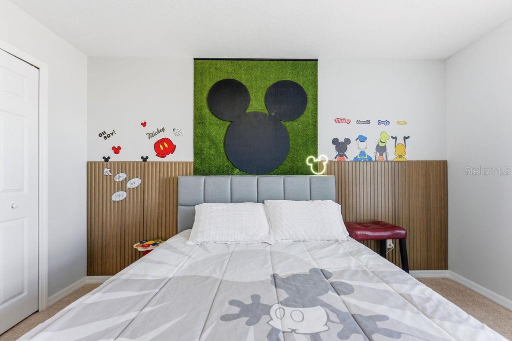 1338 Southwest 161st Place Ocala, FL 34473 - Photo 32 of 76 a bed room with a bed and a painting on the wall