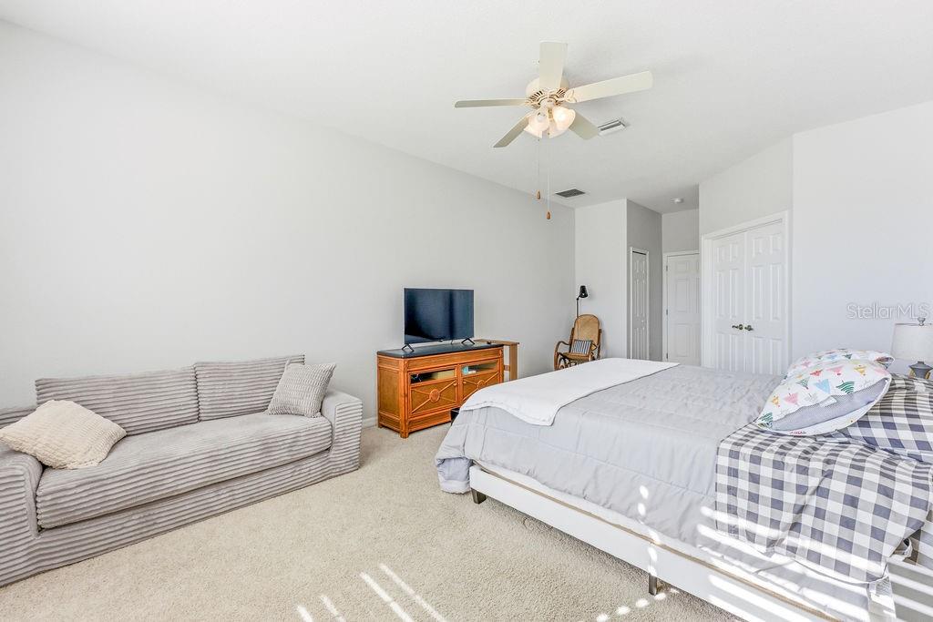 1338 Southwest 161st Place Ocala, FL 34473 - Photo 34 of 76 a bedroom with a bed and a chandelier